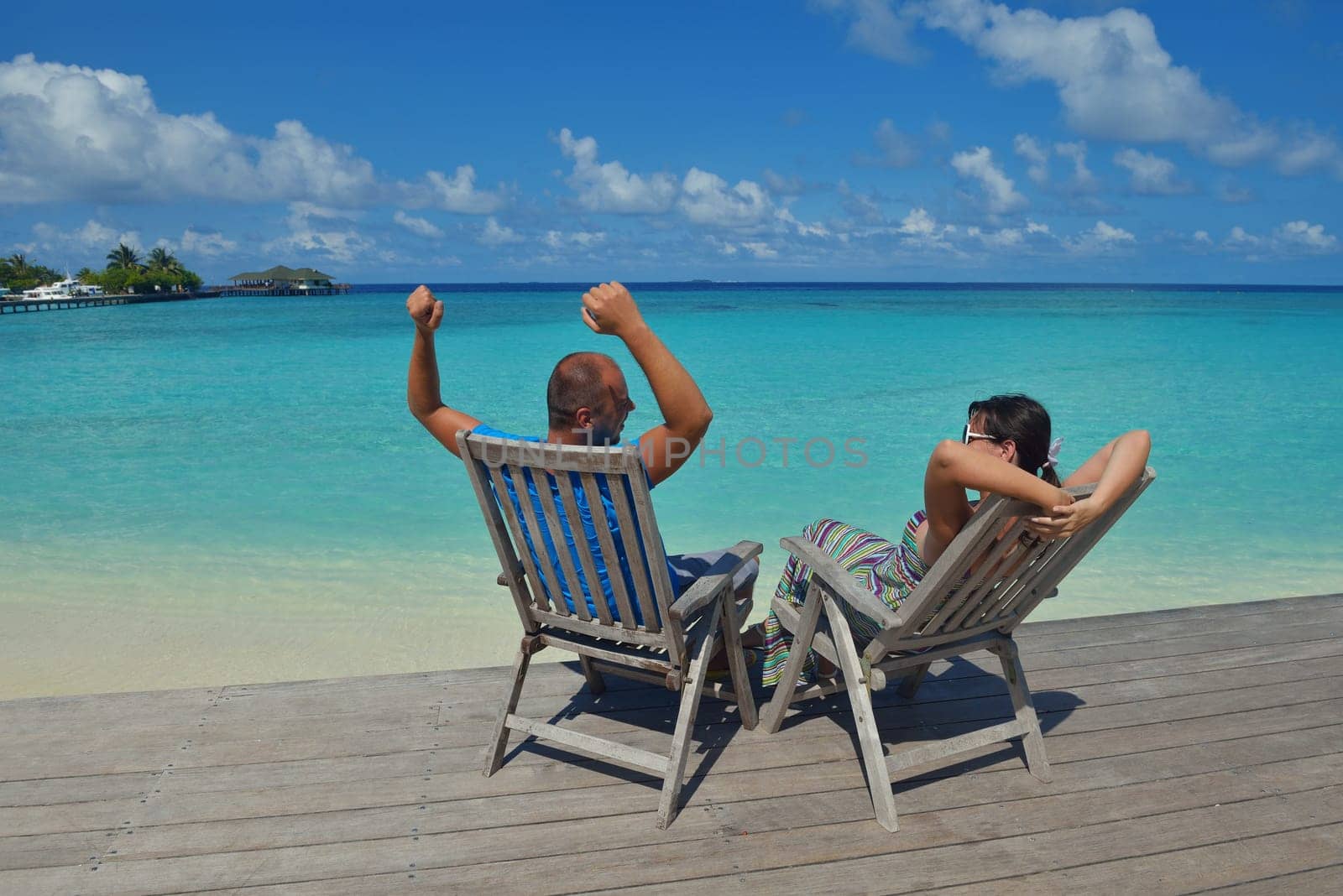 happy young couple have fun and relax at summer vacation on background maldives travel location and beautiful white sand beach