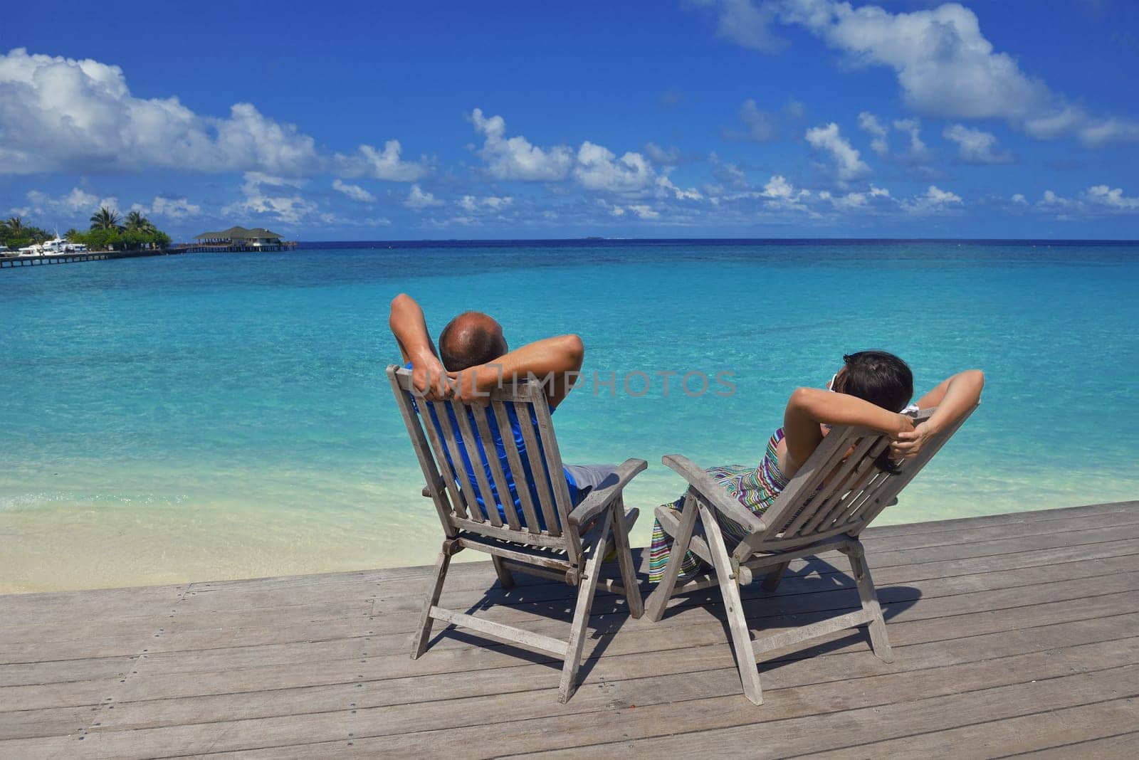 happy young couple have fun and relax at summer vacation on background maldives travel location and beautiful white sand beach