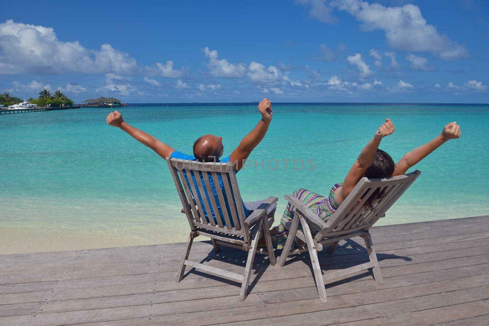 happy young couple have fun and relax at summer vacation on background maldives travel location and beautiful white sand beach