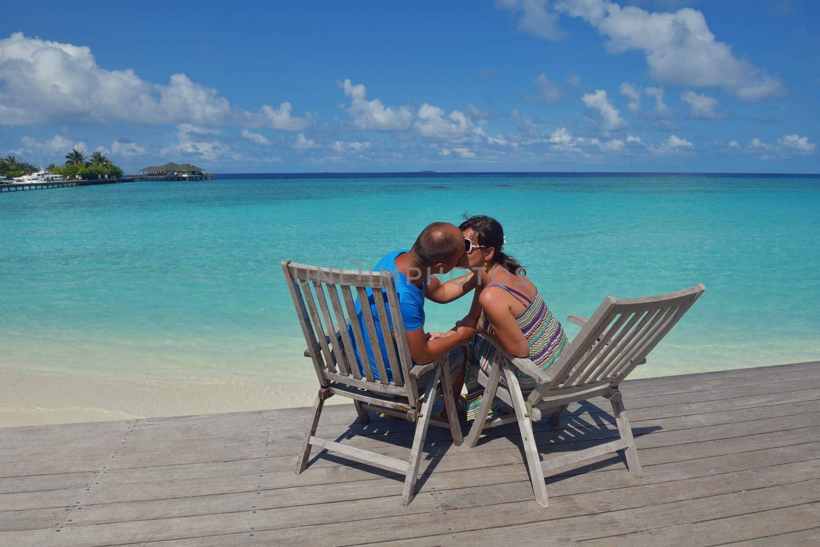happy young couple have fun and relax at summer vacation on background maldives travel location and beautiful white sand beach