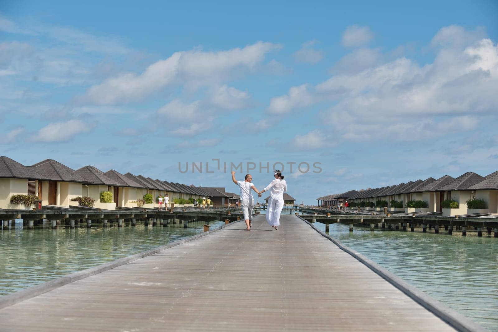 happy young couple have fun and relax at summer vacation on background maldives travel location and beautiful white sand beach