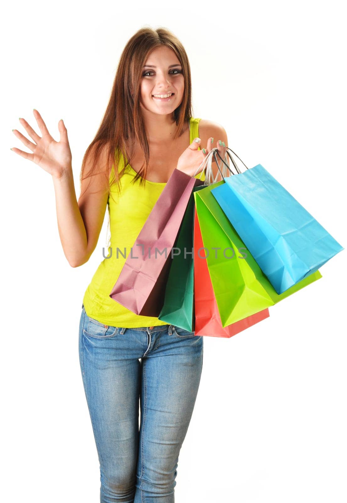Young happy woman with colorful paper shopping bags isolated on white