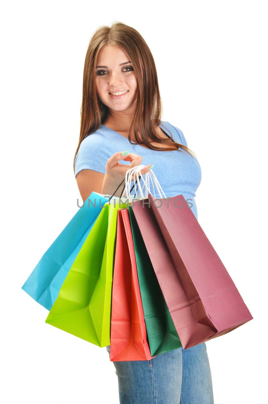 Young happy woman with colorful paper shopping bags isolated on white