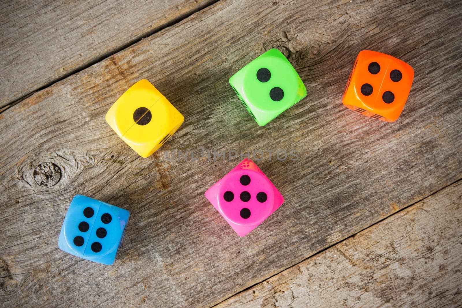 Colorful dice on the old wooden floor