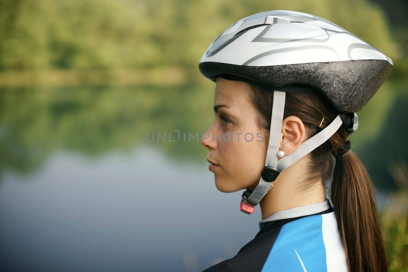 portrait of young woman training on mountain bike and contemplating landscape. Copy space