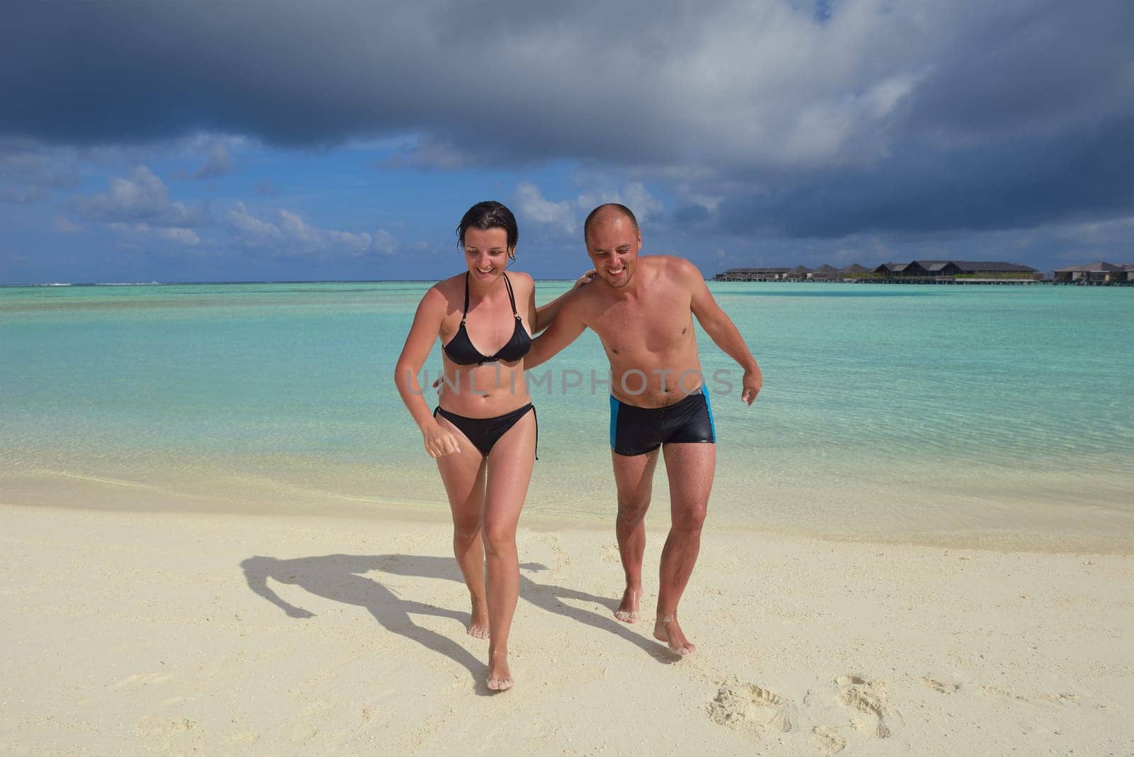happy young  couple at summer vacation have fun and relax at beautiful sunny  day on beach
