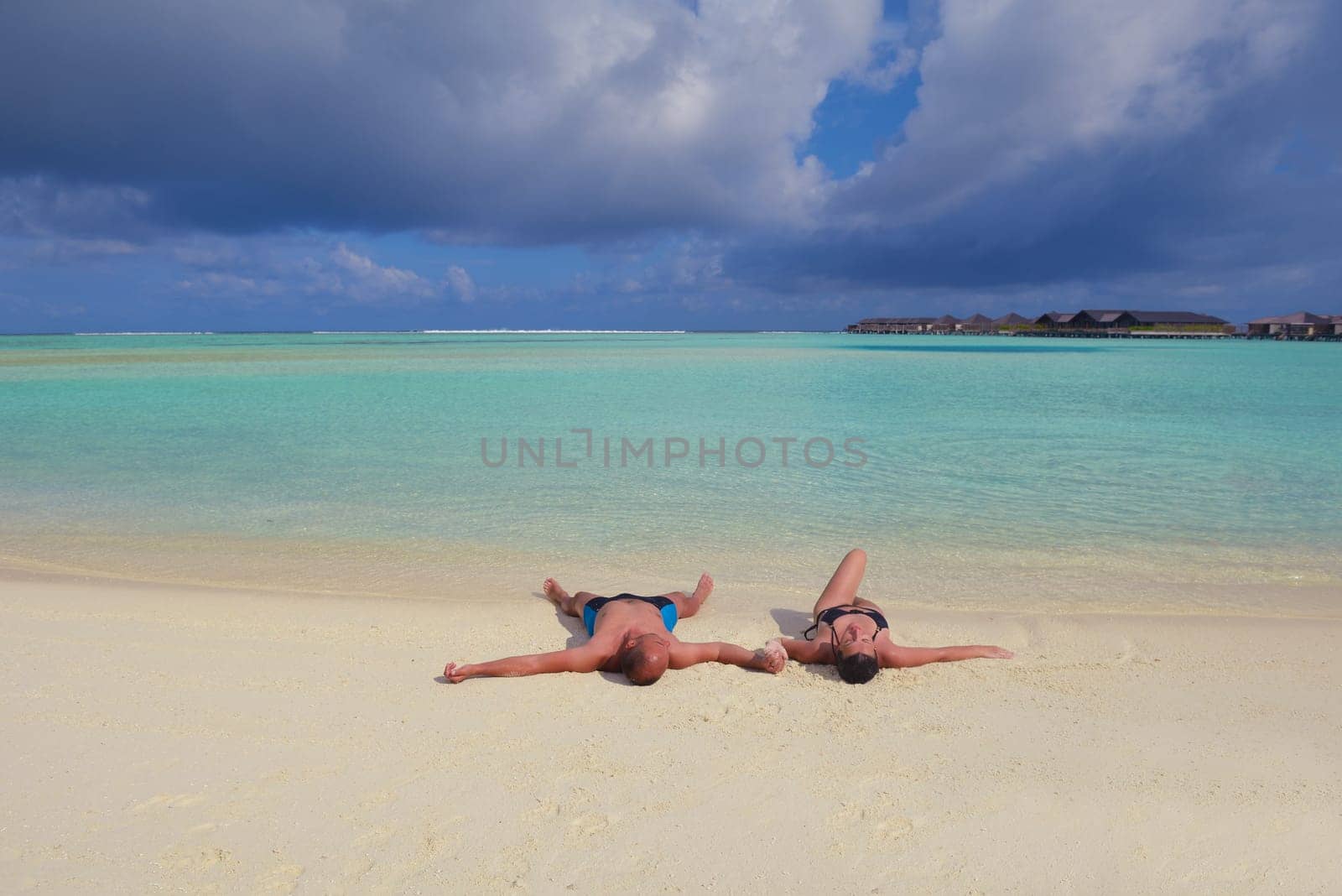 happy young  couple at summer vacation have fun and relax at beautiful sunny  day on beach