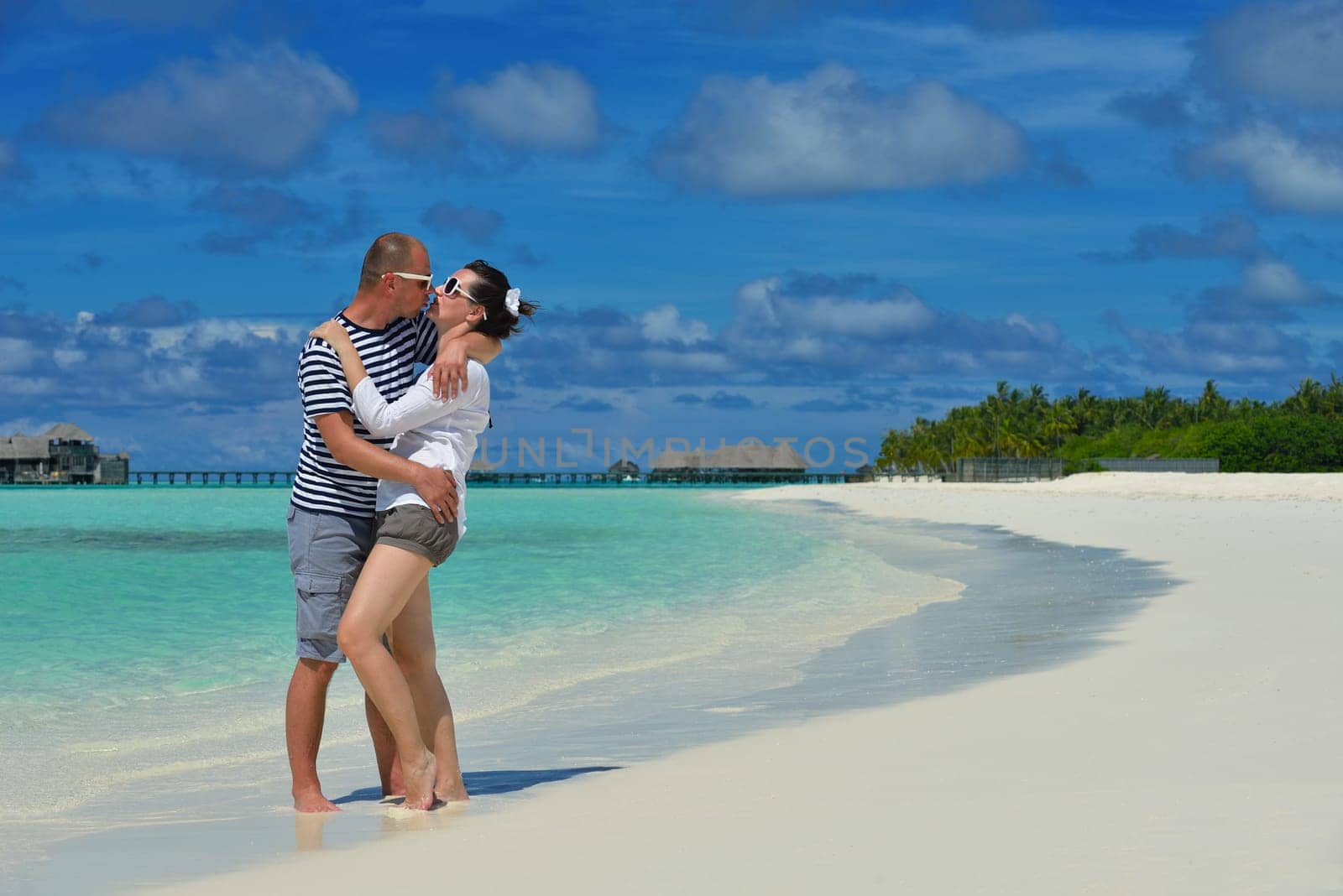 happy young  couple at summer vacation have fun and relax at beautiful sunny  day on beach
