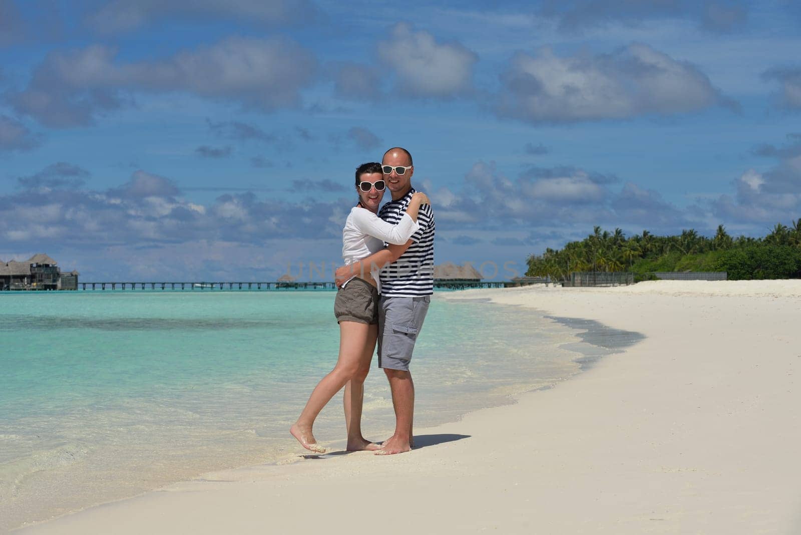 happy young  couple at summer vacation have fun and relax at beautiful sunny  day on beach