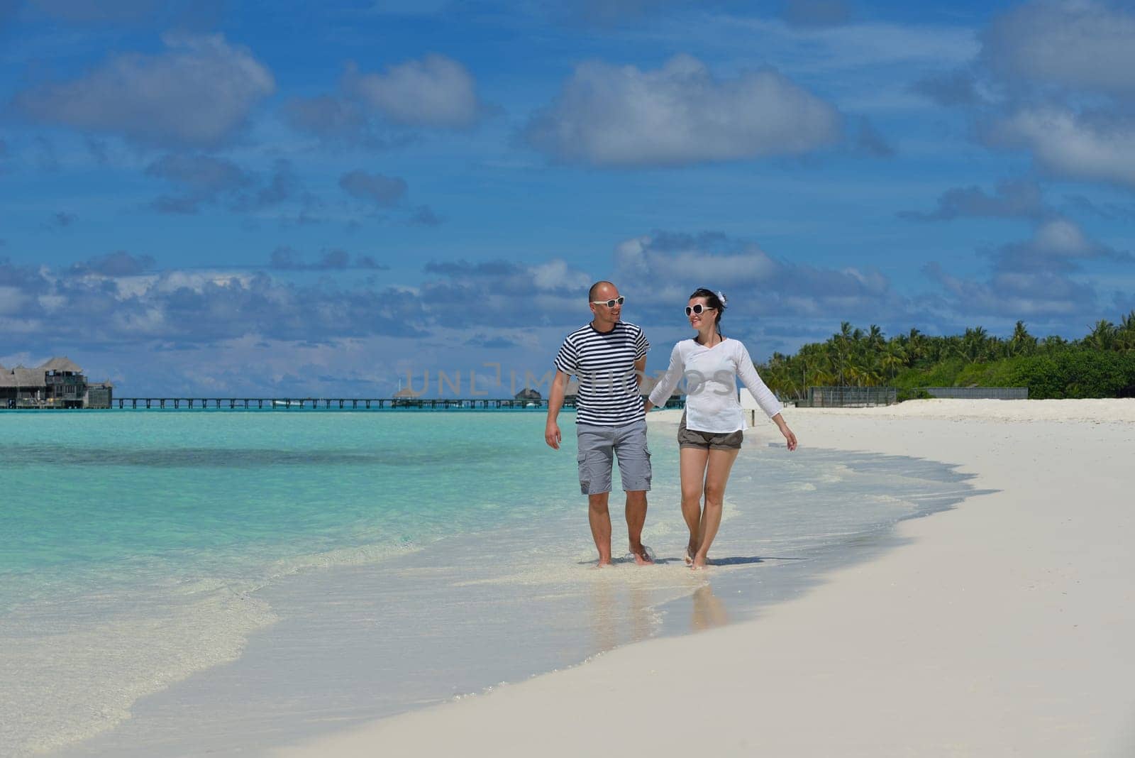 happy young  couple at summer vacation have fun and relax at beautiful sunny  day on beach
