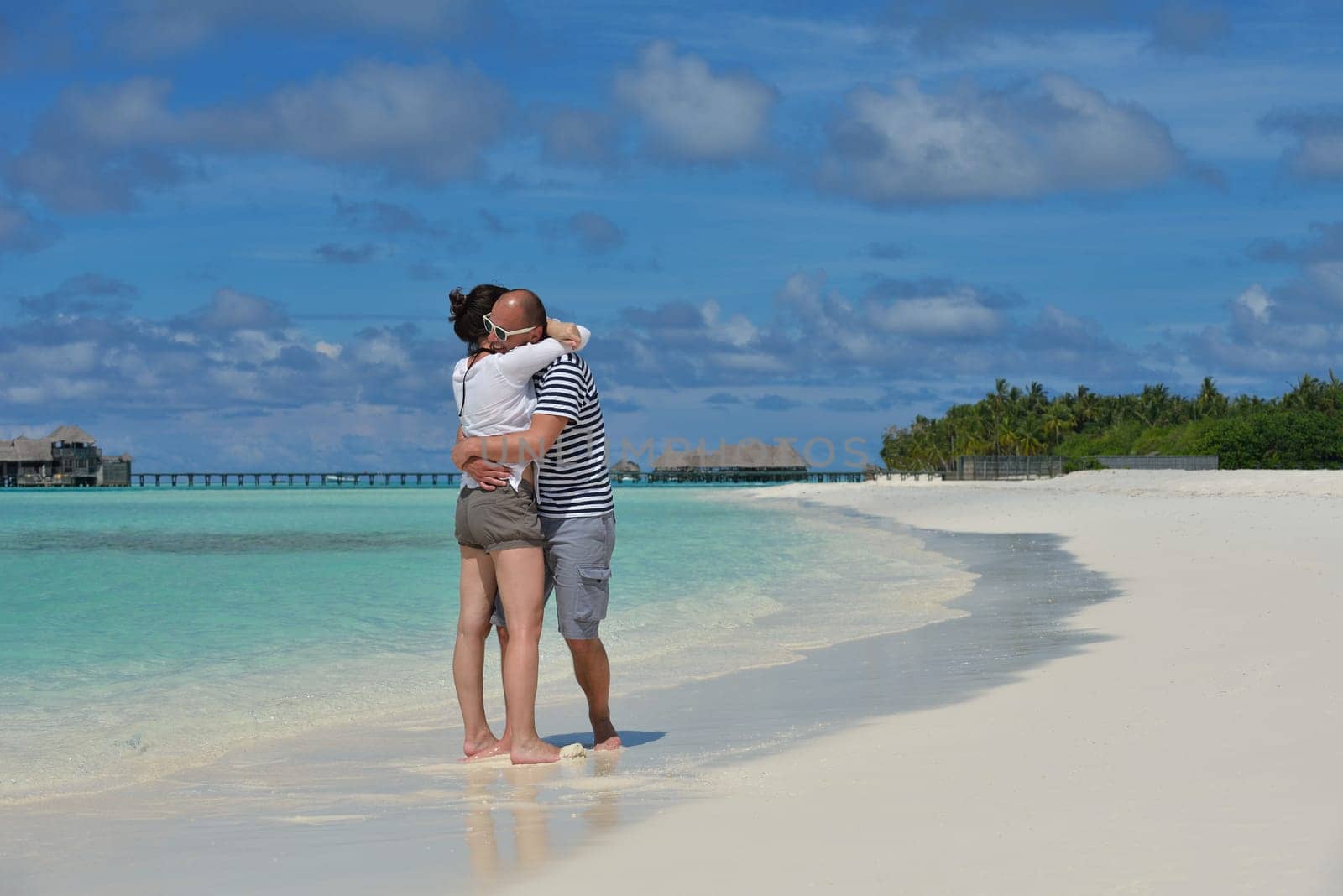 happy young  couple at summer vacation have fun and relax at beautiful sunny  day on beach