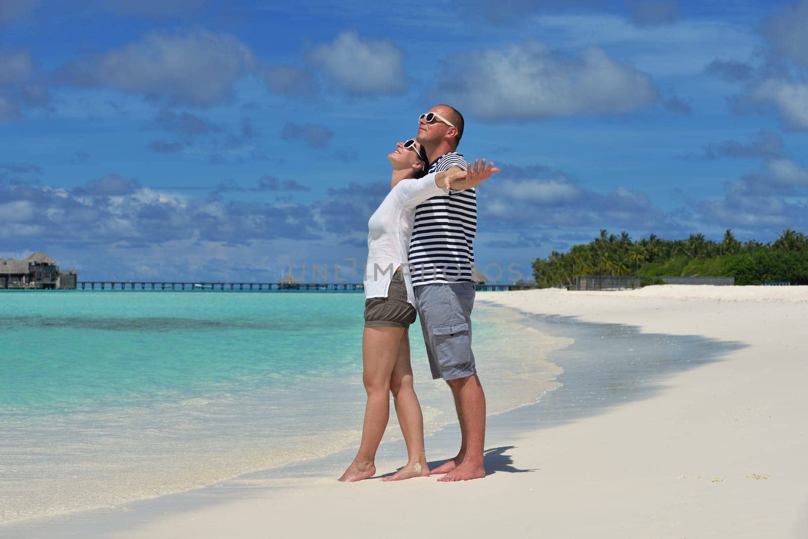 happy young  couple at summer vacation have fun and relax at beautiful sunny  day on beach