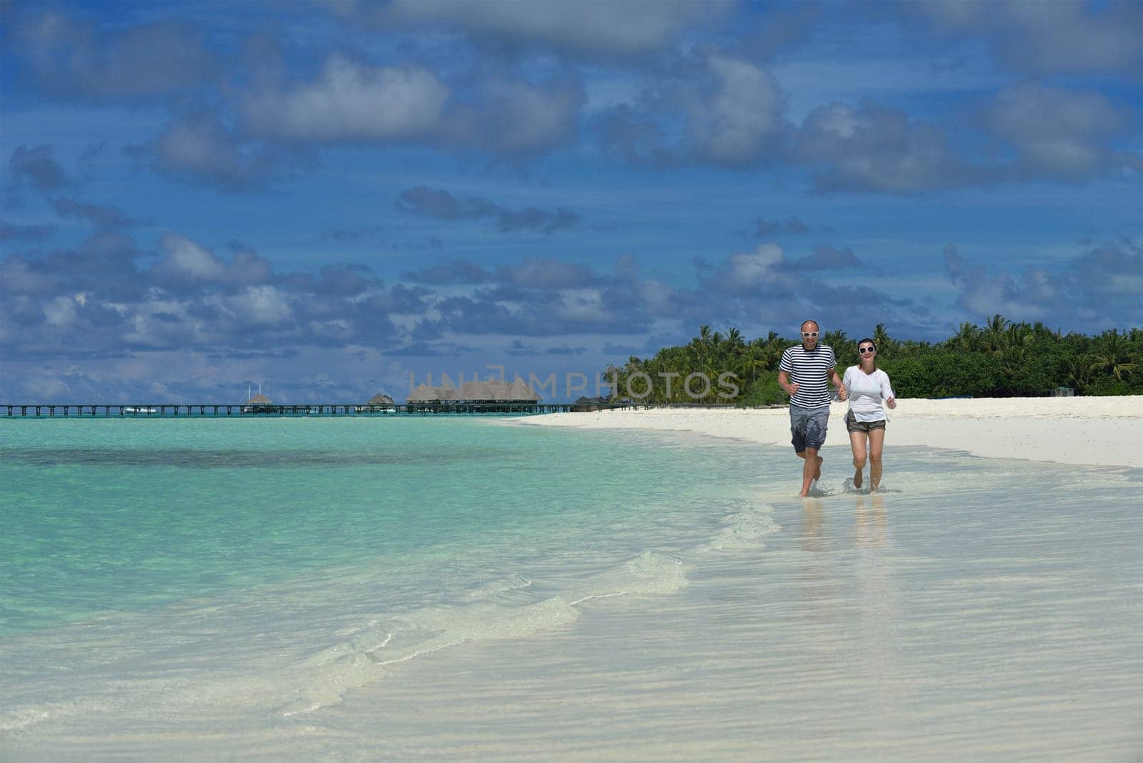 happy young  couple at summer vacation have fun and relax at beautiful sunny  day on beach