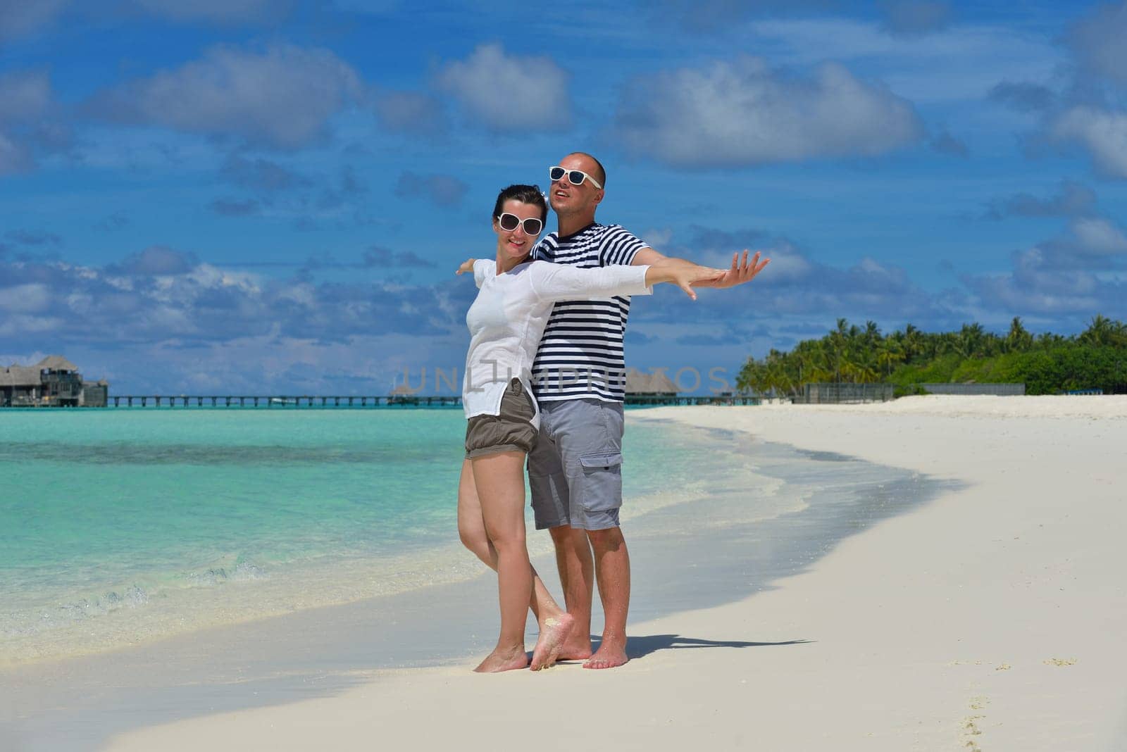 happy young  couple at summer vacation have fun and relax at beautiful sunny  day on beach