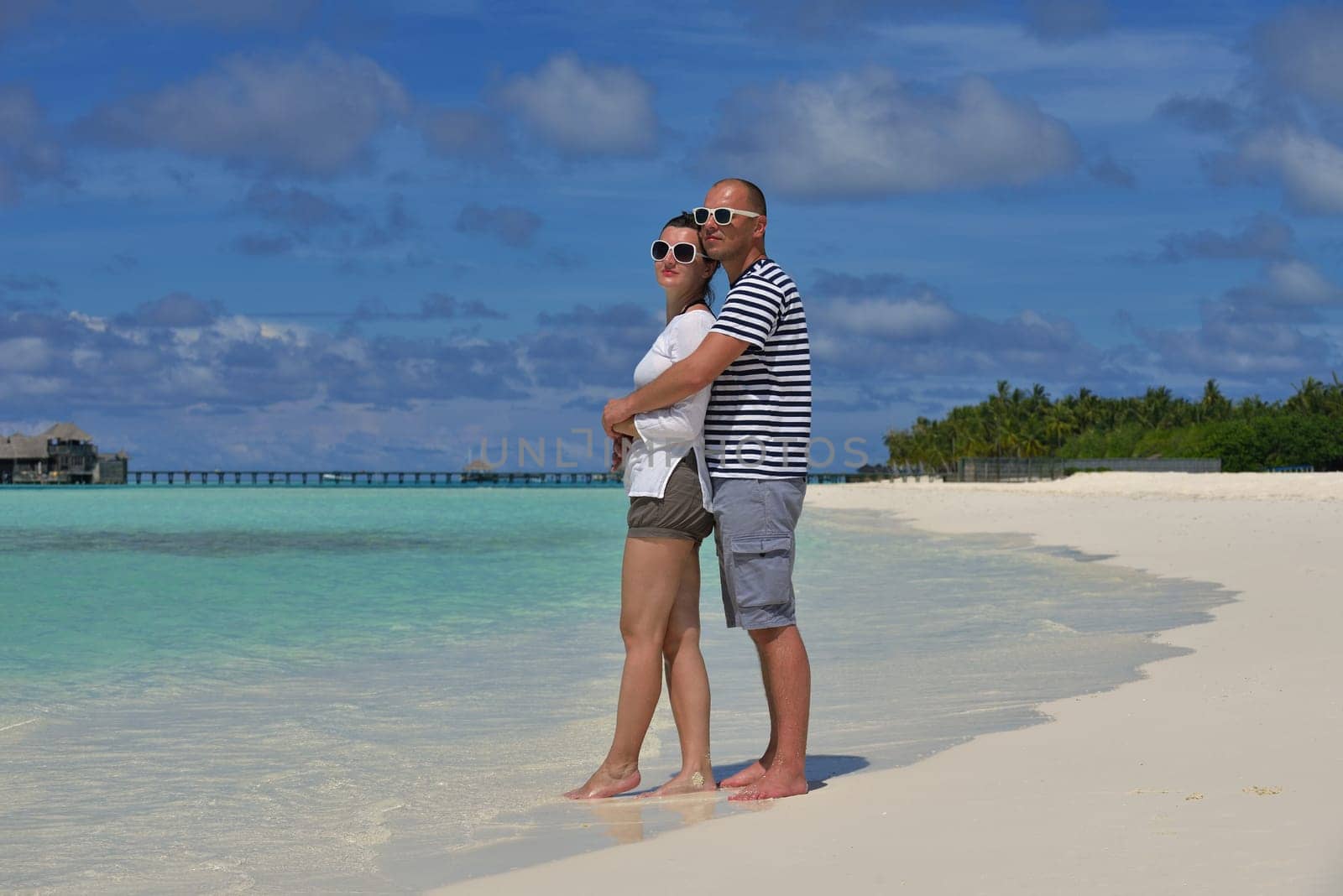 happy young  couple at summer vacation have fun and relax at beautiful sunny  day on beach