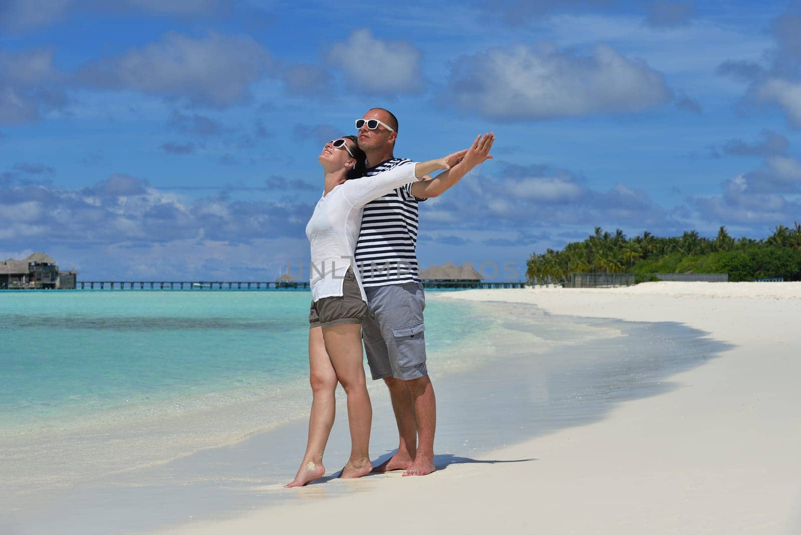 happy young  couple at summer vacation have fun and relax at beautiful sunny  day on beach