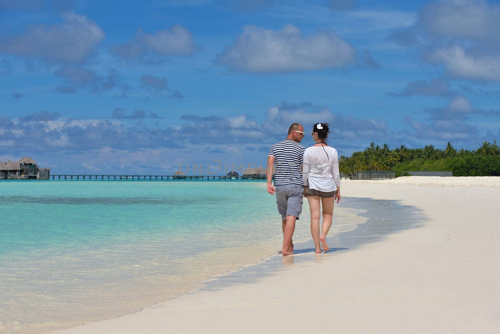 happy young  couple at summer vacation have fun and relax at beautiful sunny  day on beach