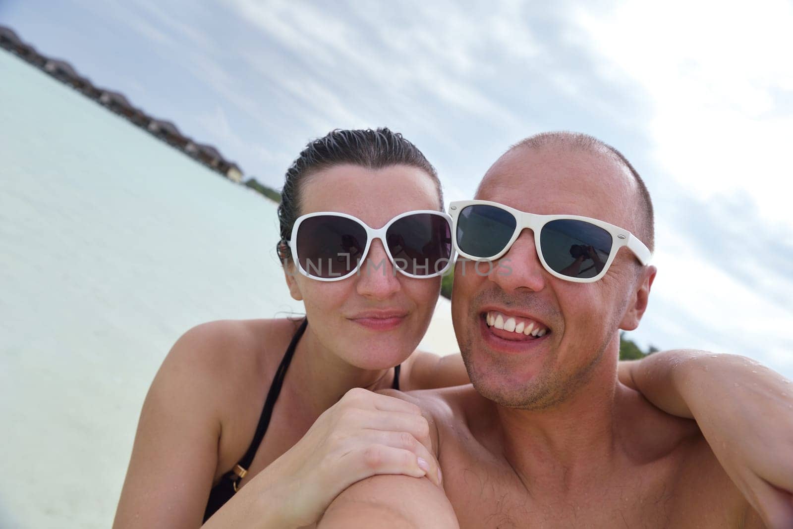 happy young  couple at summer vacation have fun and relax at beautiful sunny  day on beach