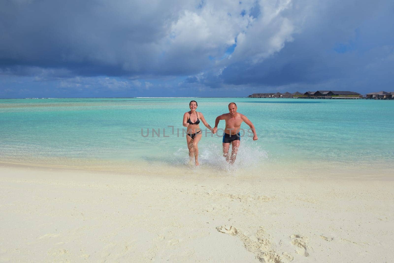 happy young  couple at summer vacation have fun and relax at beautiful sunny  day on beach