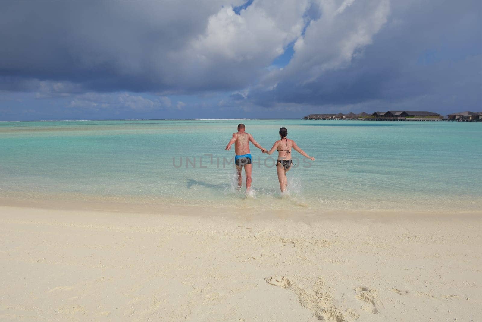 happy young  couple at summer vacation have fun and relax at beautiful sunny  day on beach