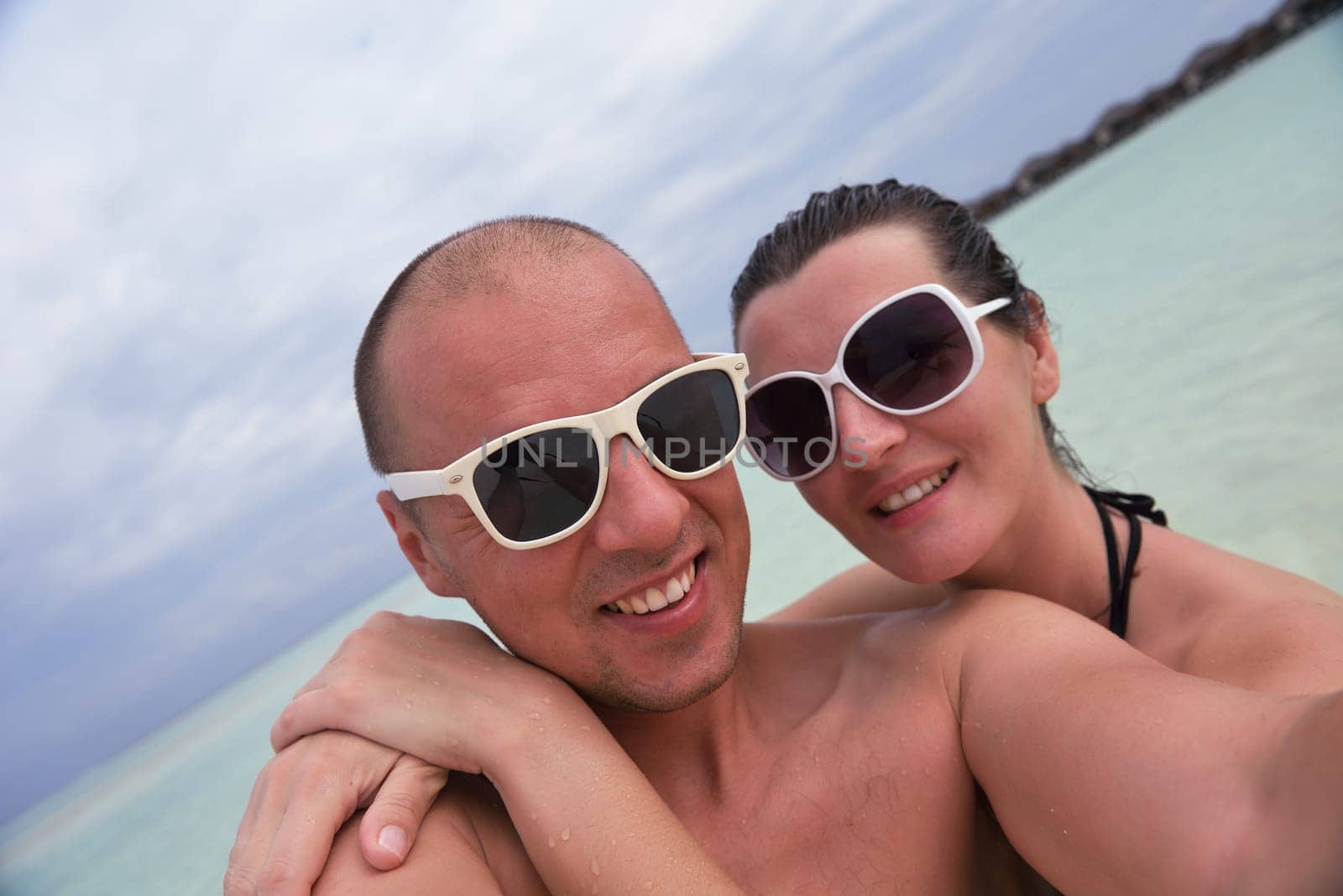 happy young  couple at summer vacation have fun and relax at beautiful sunny  day on beach
