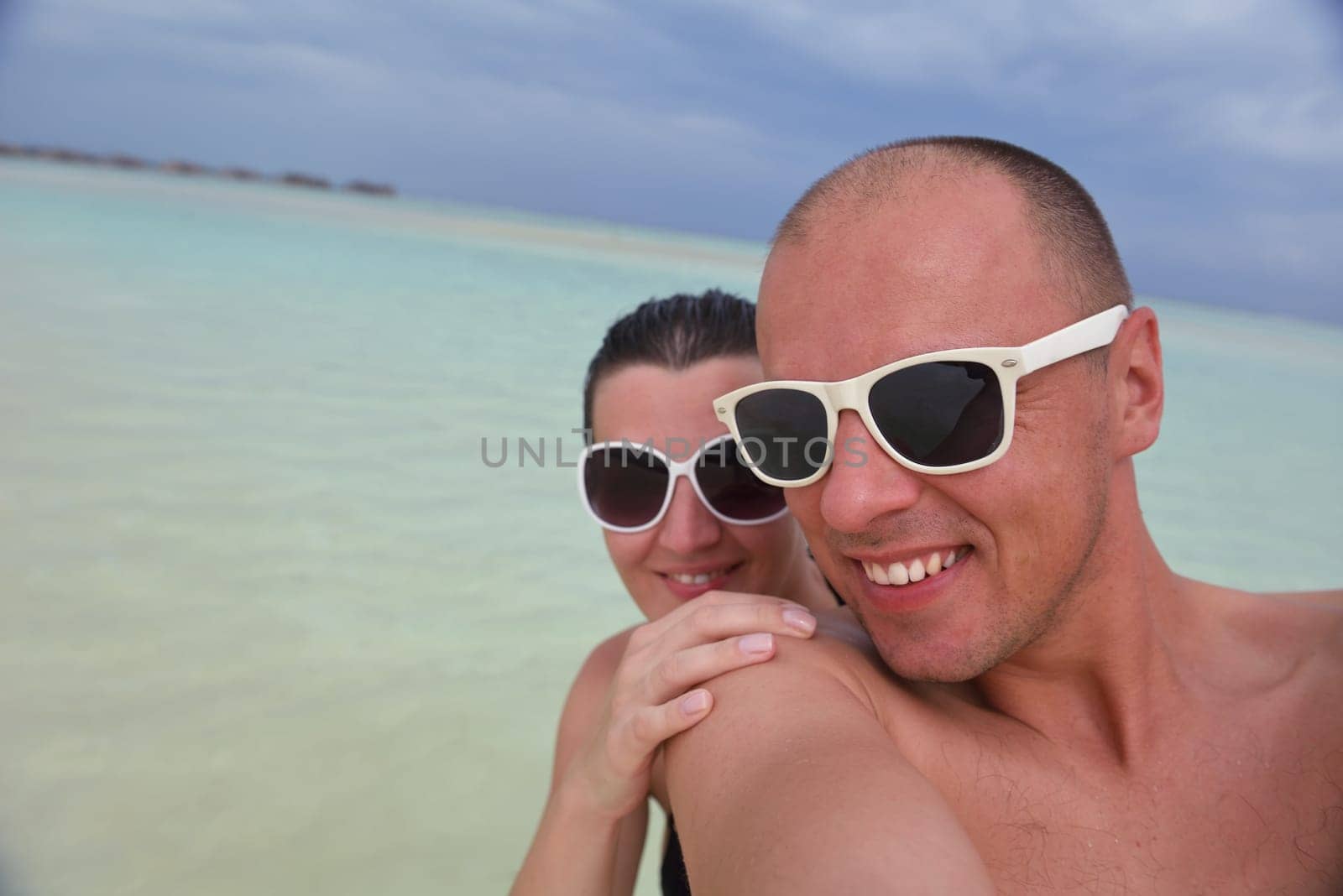 happy young  couple at summer vacation have fun and relax at beautiful sunny  day on beach