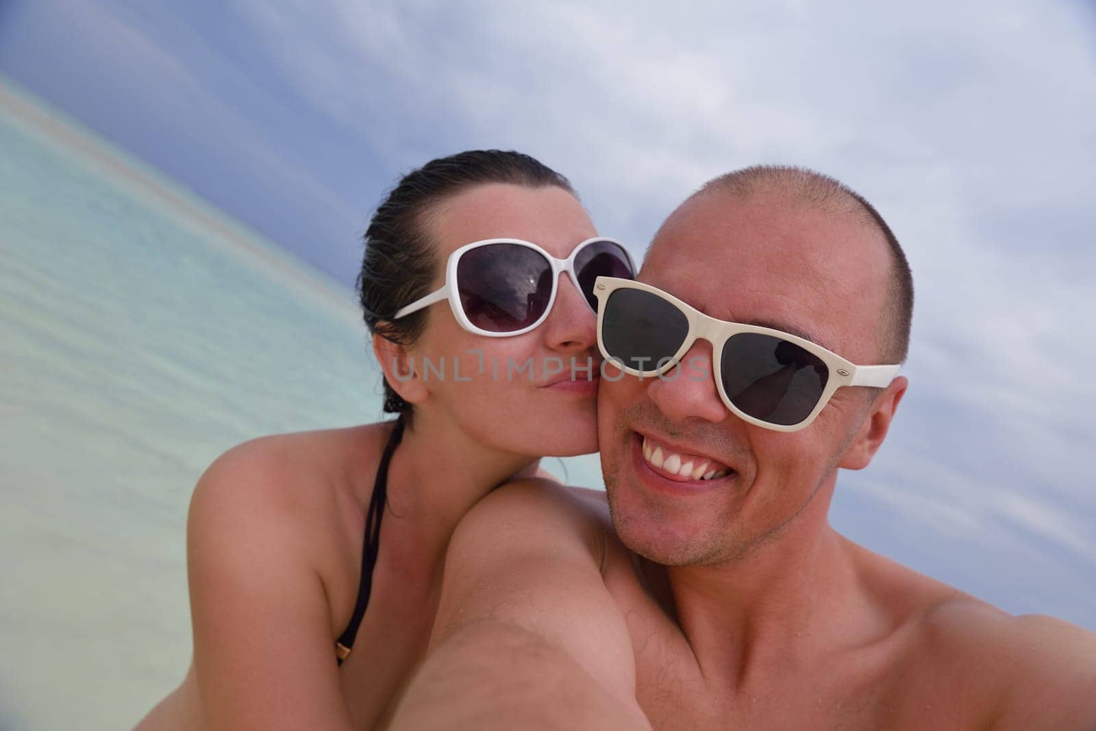 happy young  couple at summer vacation have fun and relax at beautiful sunny  day on beach