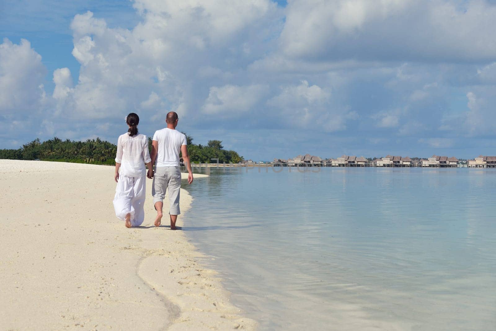 happy young  couple at summer vacation have fun and relax at beautiful sunny  day on beach