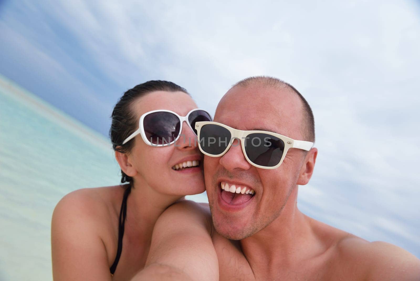 happy young  couple at summer vacation have fun and relax at beautiful sunny  day on beach
