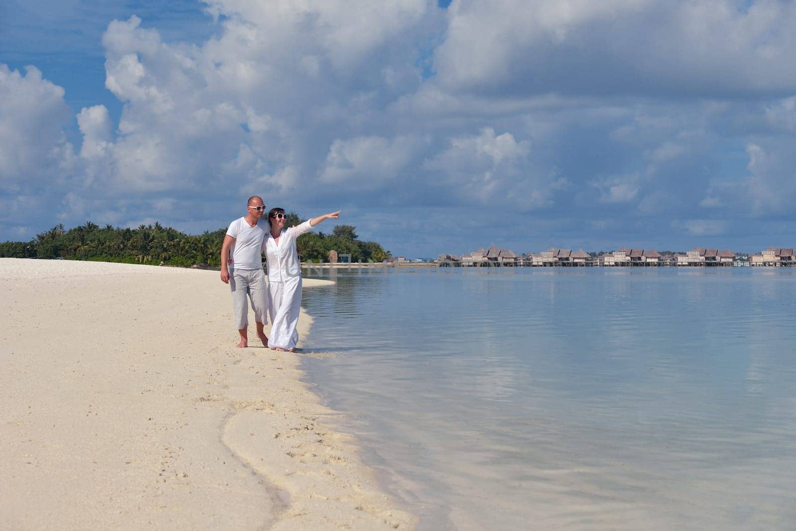 happy young  couple at summer vacation have fun and relax at beautiful sunny  day on beach