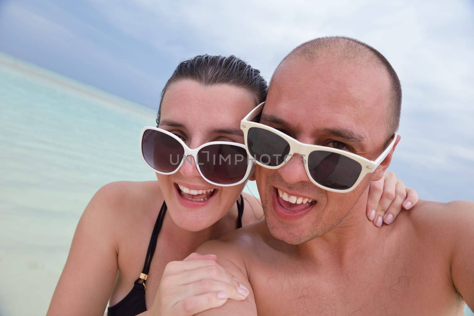 happy young  couple at summer vacation have fun and relax at beautiful sunny  day on beach