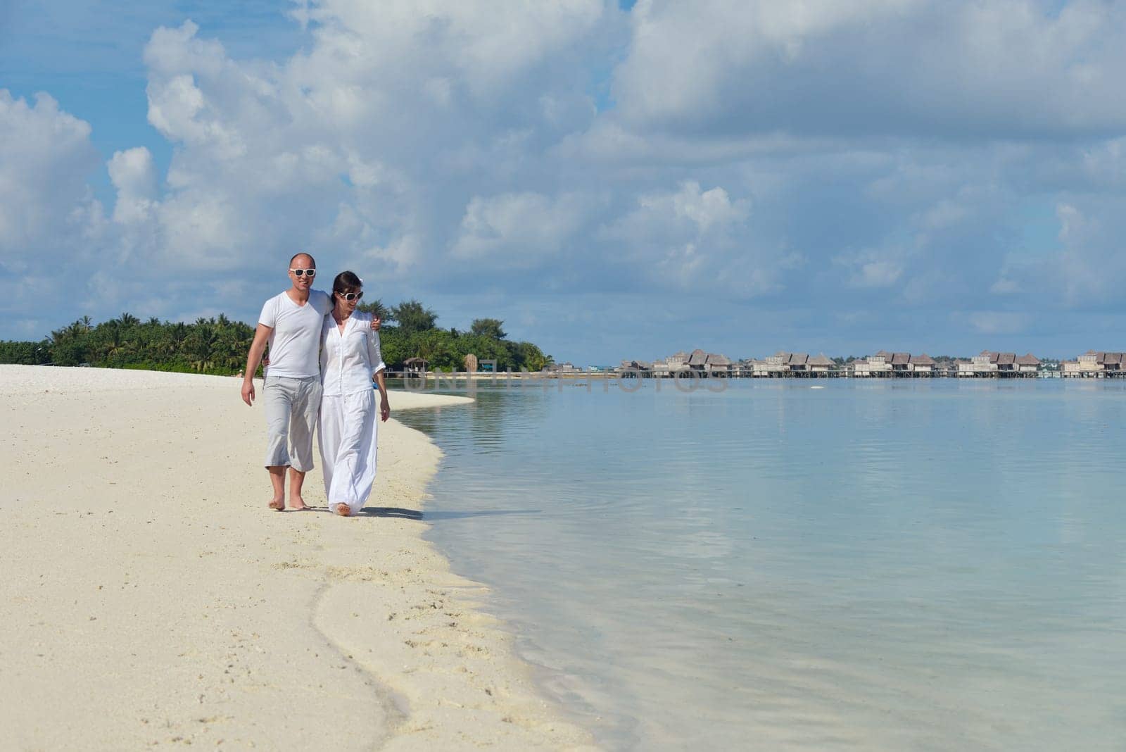 happy young  couple at summer vacation have fun and relax at beautiful sunny  day on beach