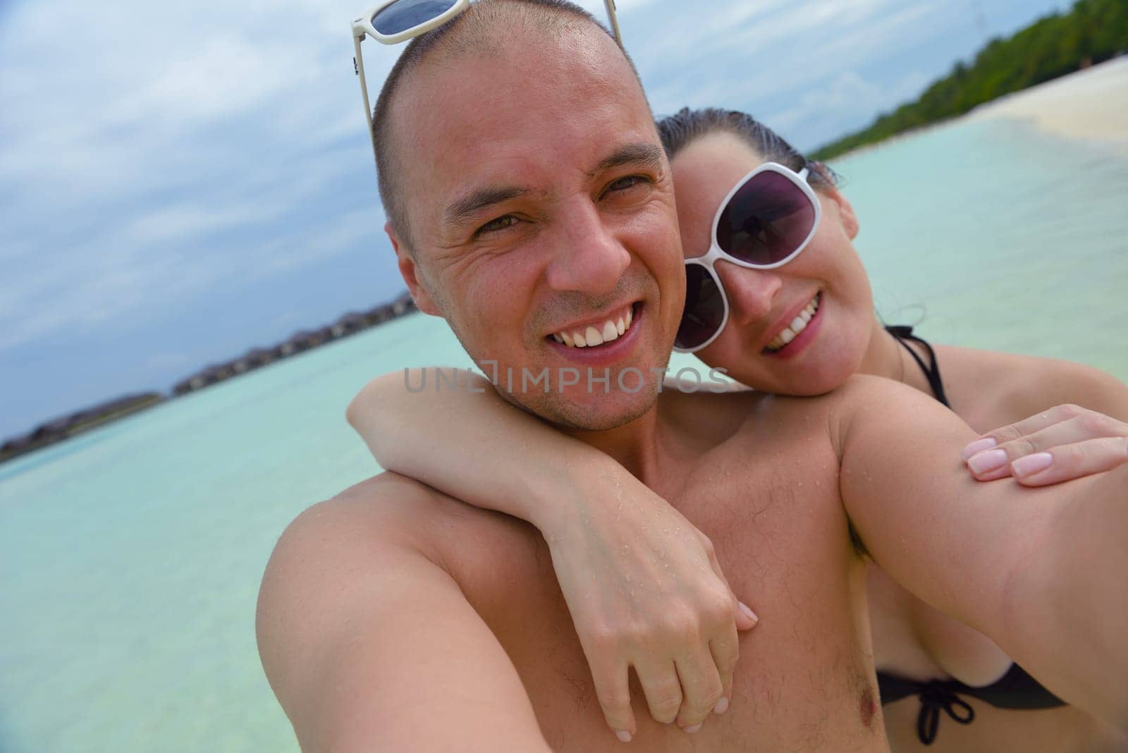 happy young  couple at summer vacation have fun and relax at beautiful sunny  day on beach