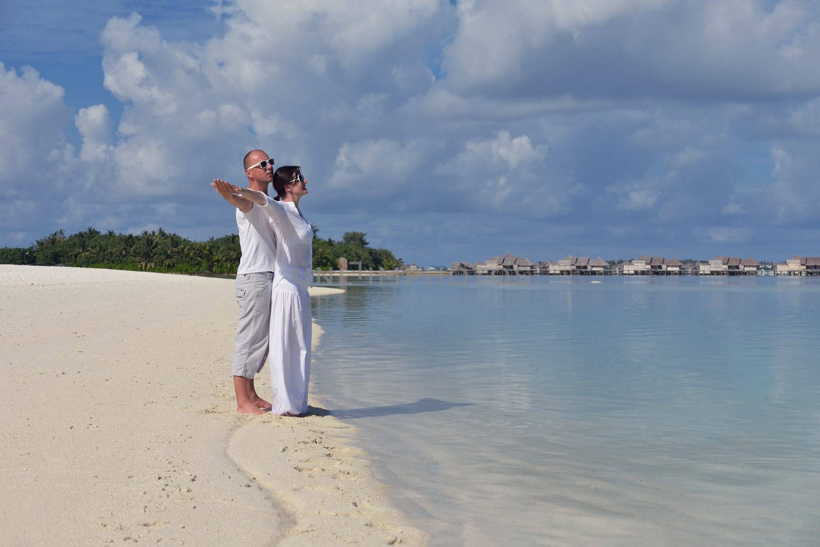 happy young  couple at summer vacation have fun and relax at beautiful sunny  day on beach