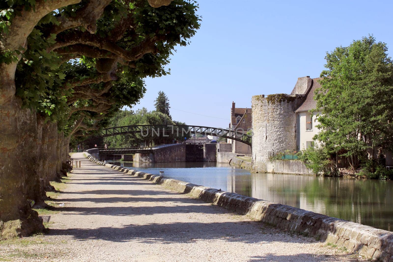 bridge rainbow sky on channel briare to montargis bordered by trees