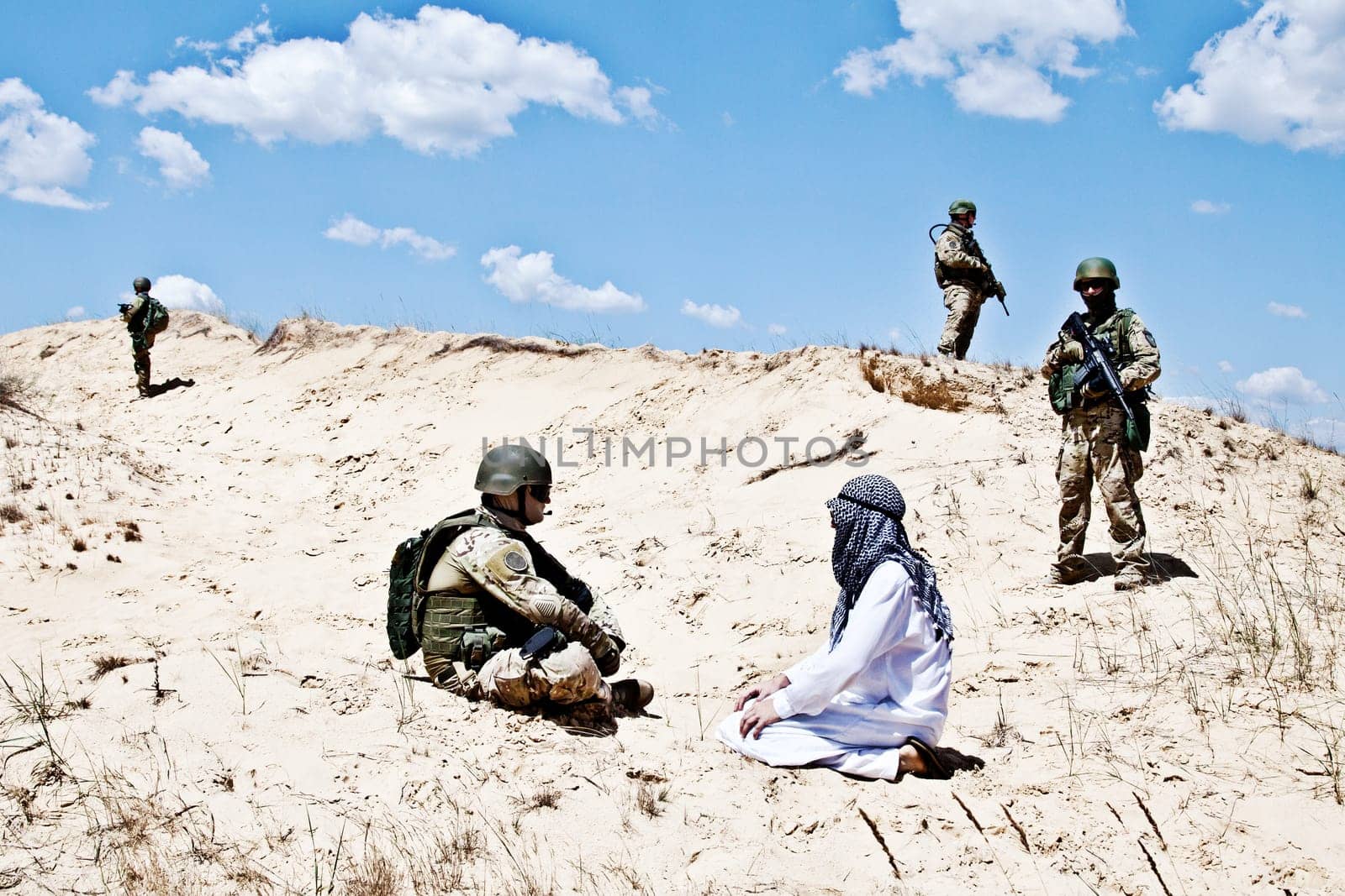 Squad of soldiers guarding the perimeter while negotiations with muslim warrior are going on