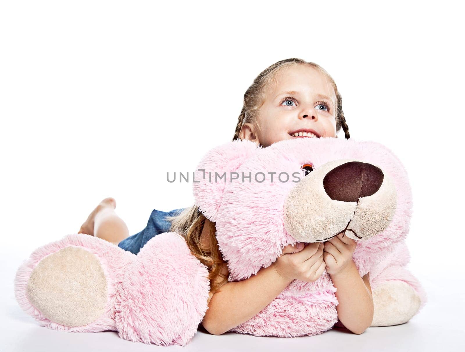 pretty little girl with plushies on white background