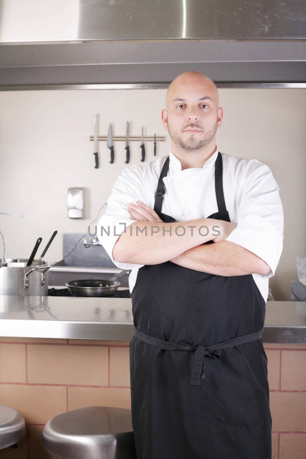 Male Chef Standing Next To Cooker In  Kitchen