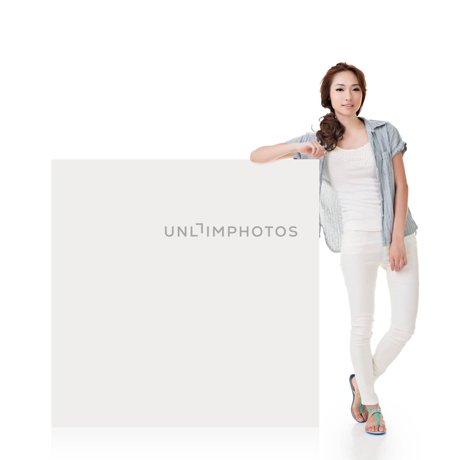 Attractive Asian woman lean on blank board of advertisement on white background.
