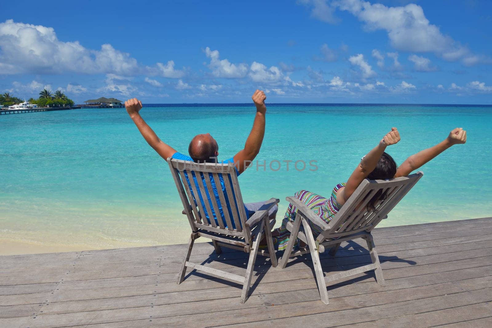 happy young couple have fun and relax at summer vacation on background maldives travel location and beautiful white sand beach