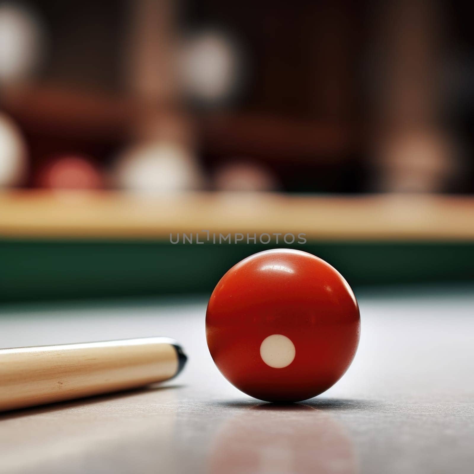 A billiard ball and a cue stick on a table