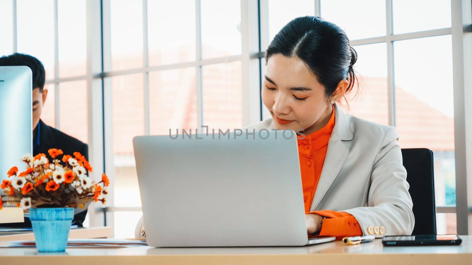 Business people working at table in modern office room while analyzing financial data report . Jivy