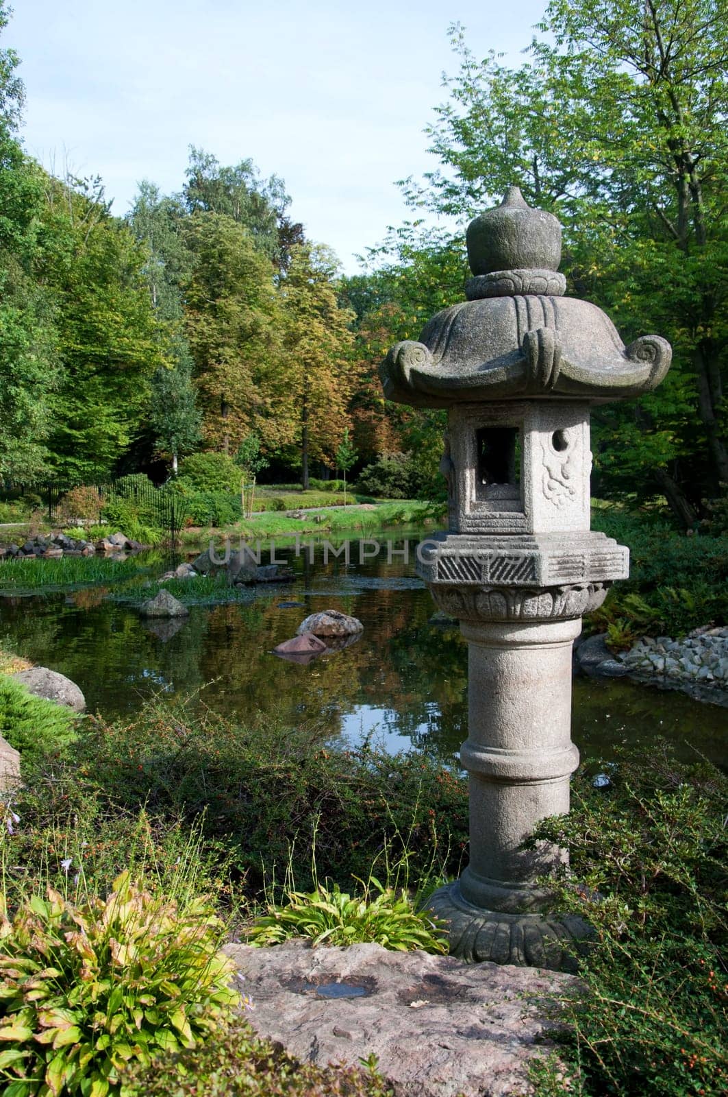 view into japanease garden with small lake and river