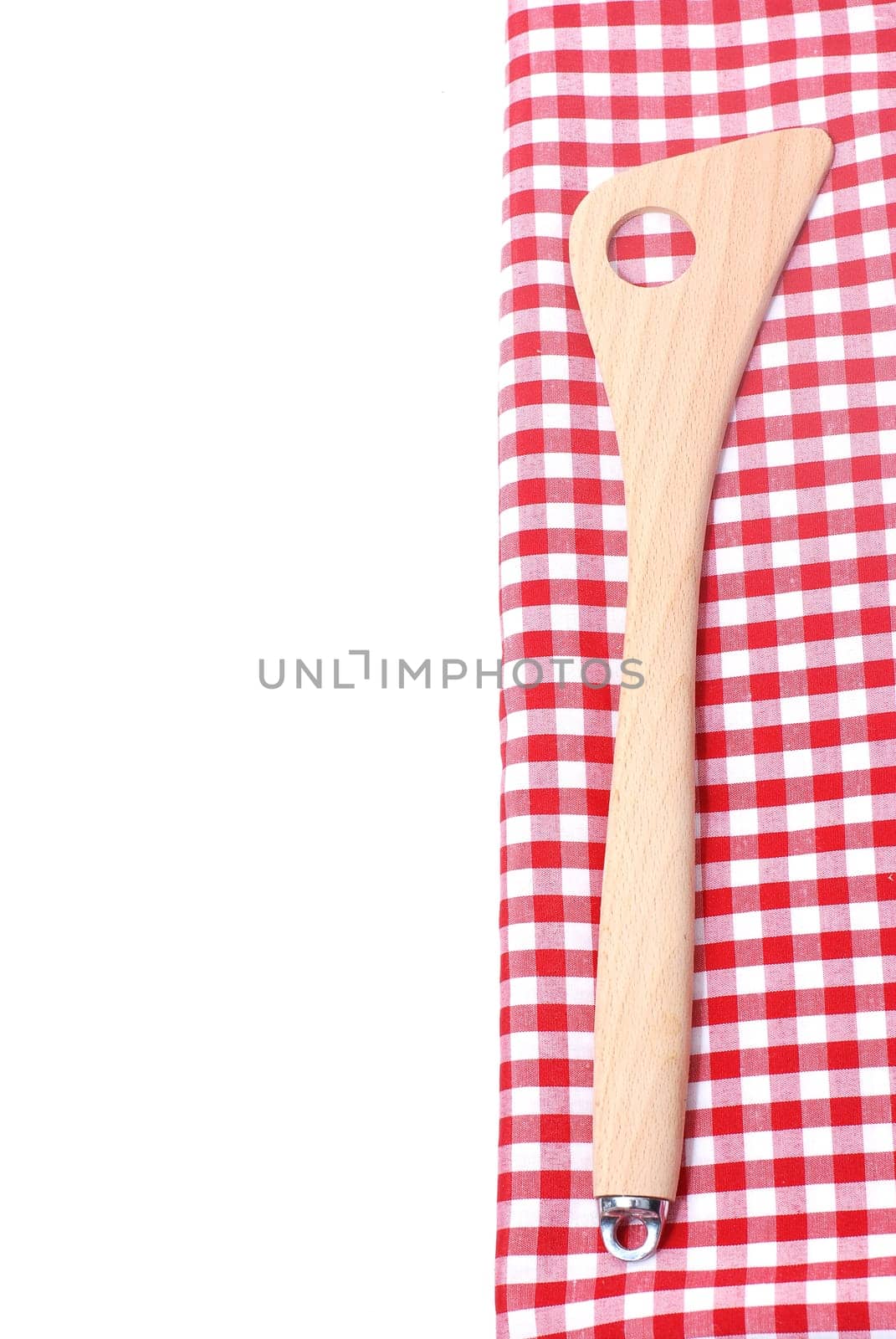 Wooden spoon on checkered fabric