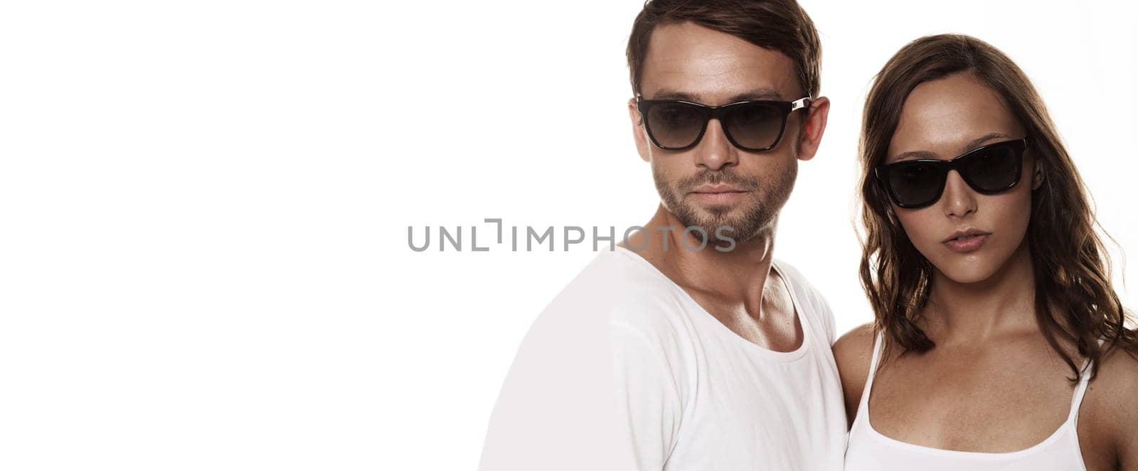 Couple wearing sunglasses isolated over a white background