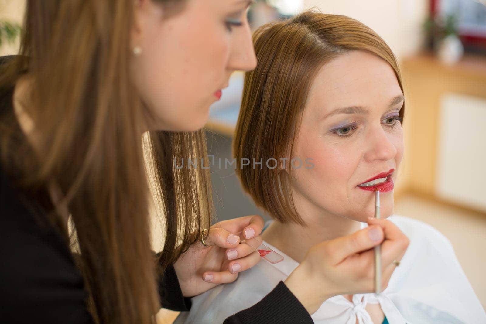 cosmetician lip gloss or lipstick for customer