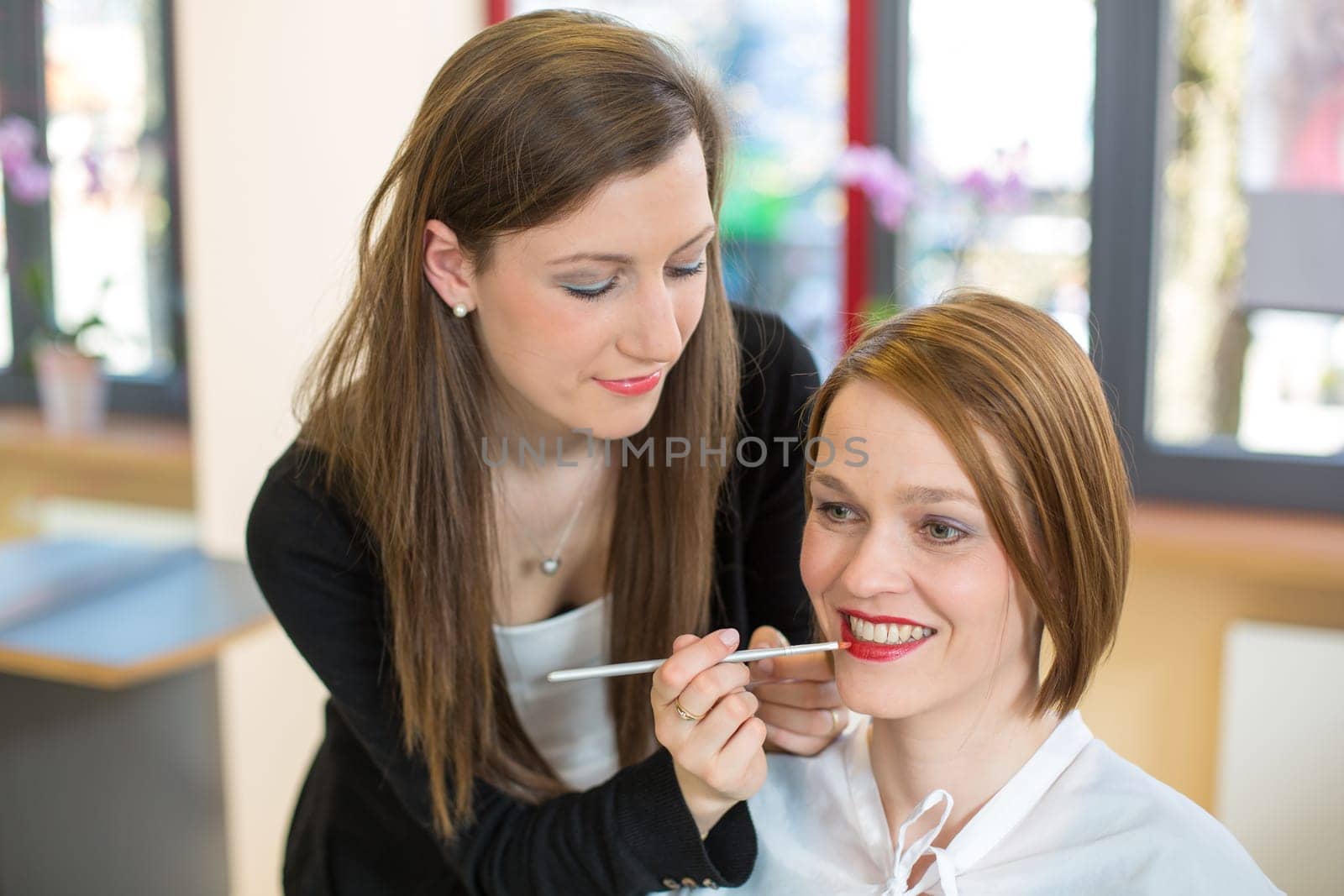cosmetician lip gloss or lipstick for customer