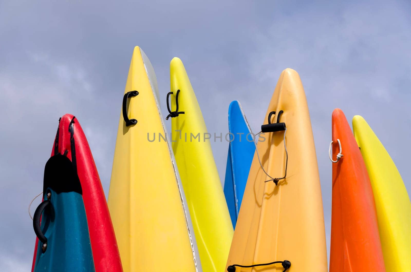 colorful canoes with cloudy sky