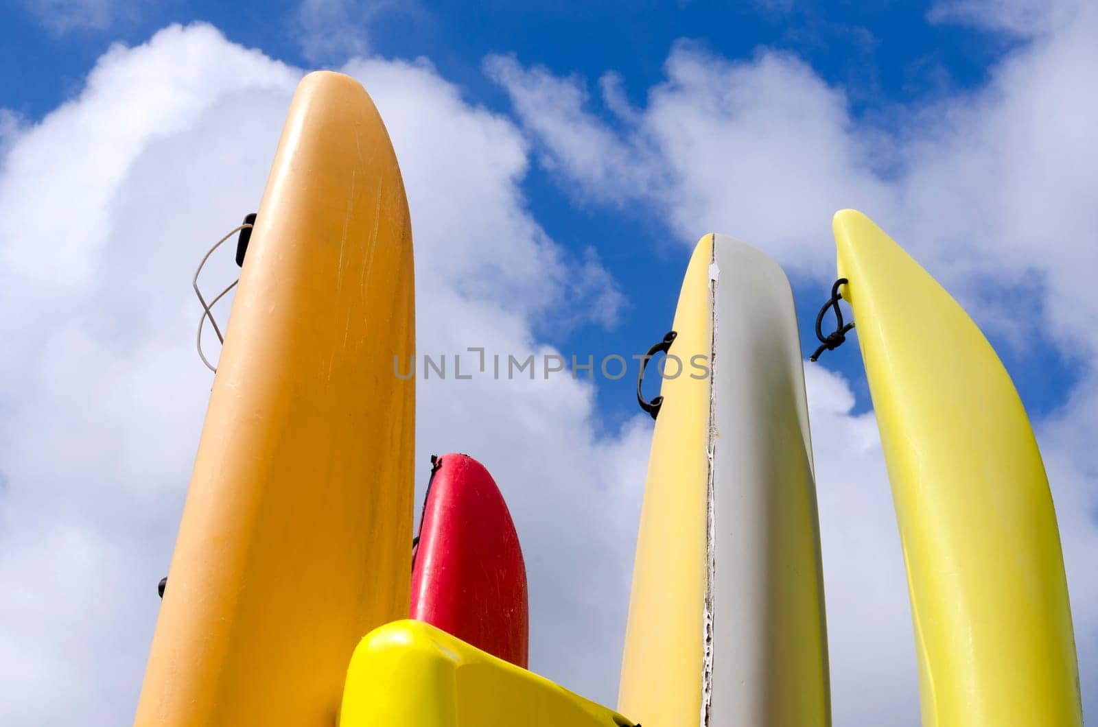 colorful canoes with cloudy sky