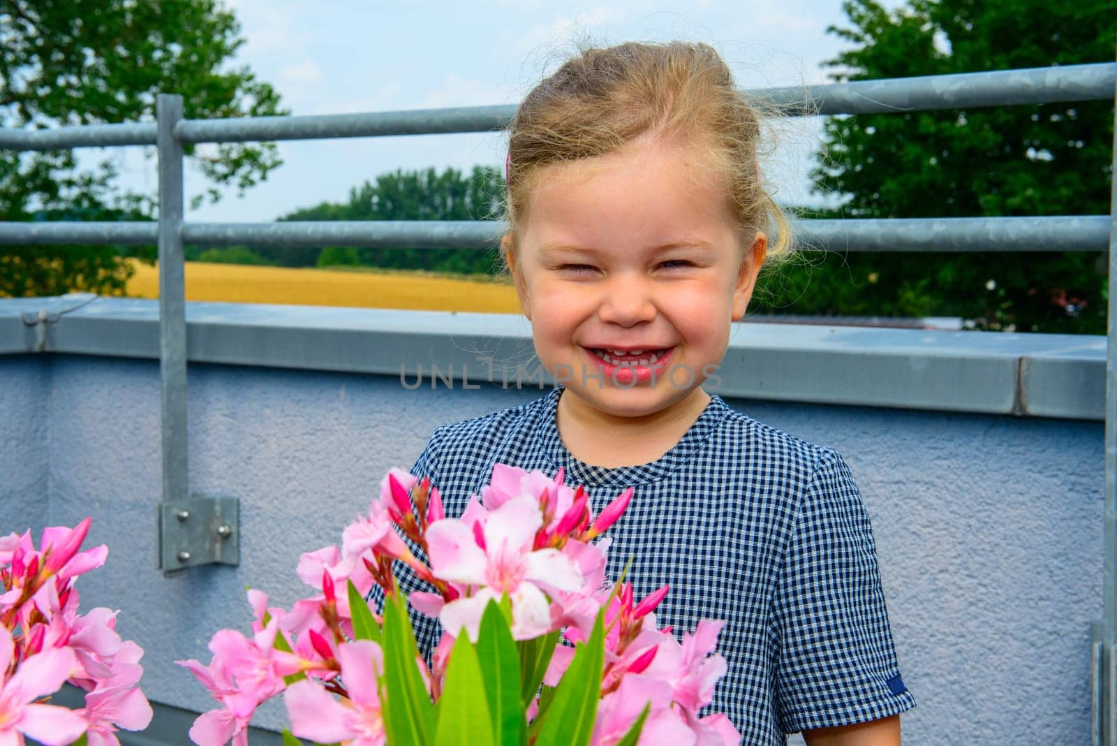 happy girl behind flowers